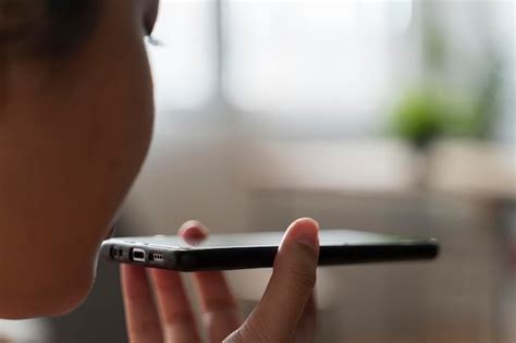 Woman Using Voice Recognition On Smart Phone To Record Messages Woman