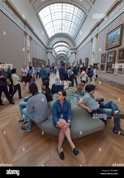 Interior Of Corridor Full Of Tourists In The Louvre Museum In Paris