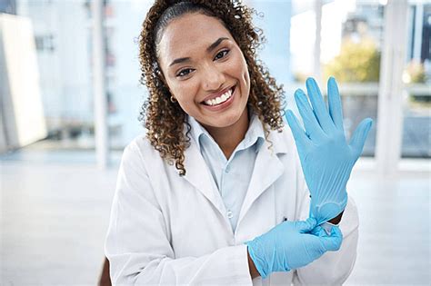 Medical Scientist In Ppe Gear Examining Disease Diagnosis With Tablet