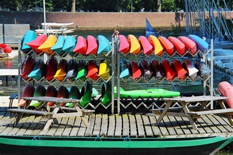 Premium Photo Colorful Kayaks On Shelf Against River