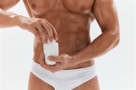 Man Bodybuilder Boxer With Naked Torso With Abs Holding A Can Of Muscle