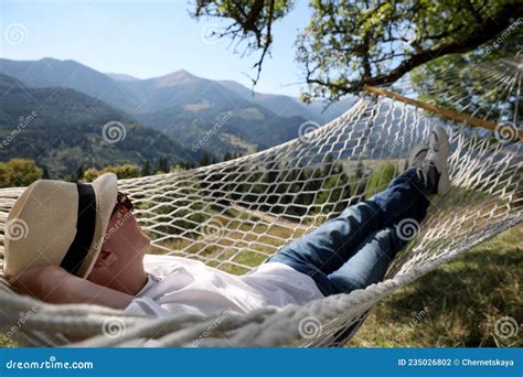 Young Man Resting In Hammock Outdoors On Sunny Day Stock Photo Image