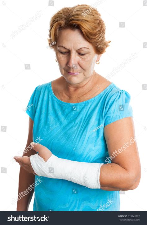 Senior Hispanic Woman With A Broken Arm On A Plaster Cast Isolated On