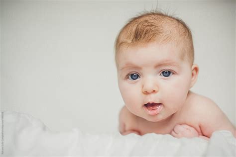 Close Up Of Cute Naked Baby Girl With Blue Eyes Del Colaborador De Stocksy Rob And Julia
