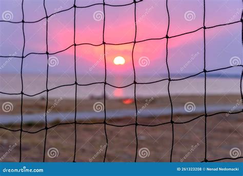 View of the Sunset through the Volleyball Net. Dramatic Sunset Over Sea ...