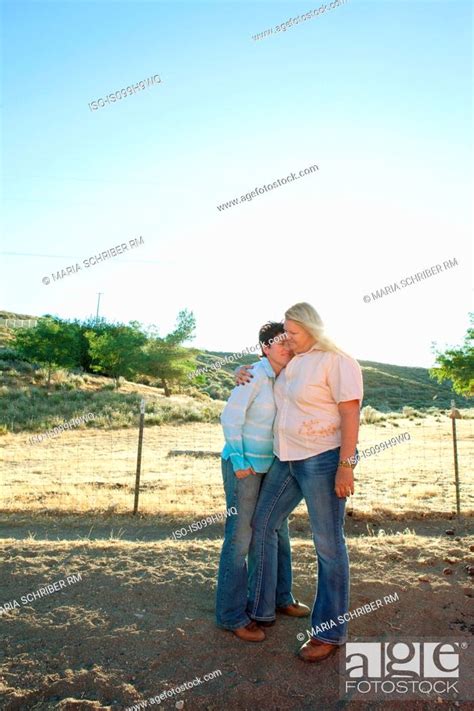 Mature Lesbian Couple Embracing On Ranch Stock Photo Picture And