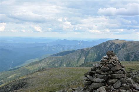 Scenic Landscape of a Pile of Rocks in Green Fields with Mountains in ...