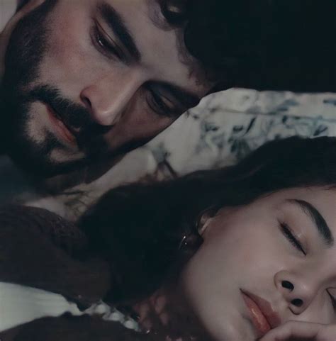 A Man And Woman Laying Next To Each Other