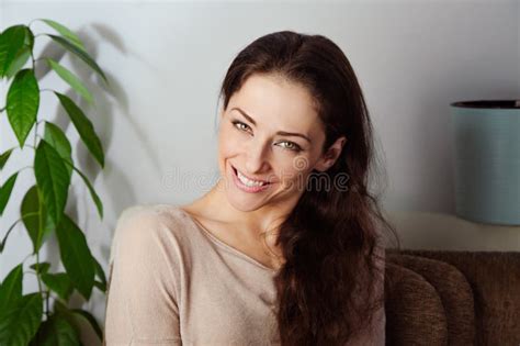Happy Carefree Brunette Long Brown Hair Woman With Cute Calm Smile Looking Happy And Sitting On