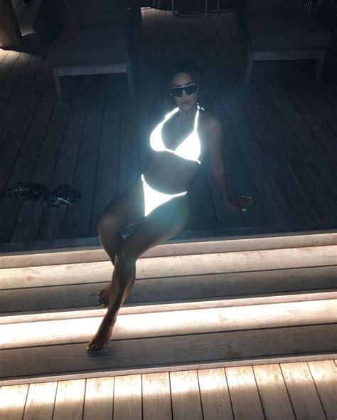 Kim Kardashian Poses In Glowing White String Bikini