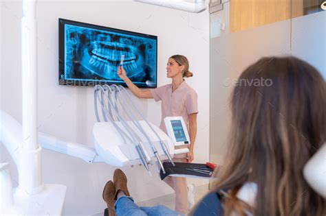 Dentist showing X ray image to patient Stock Photo by Unai82 | PhotoDune