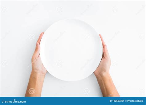 Female Hands Holding Empty Plate On White Background Stock Image