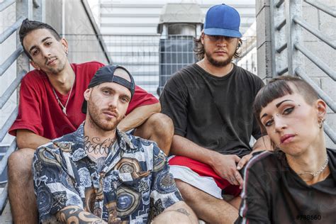 Group of young rappers posing sitting on the metal stairs - stock photo ...