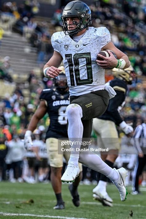 Quarterback Bo Nix Of The Oregon Ducks Jumps Into The End Zone For A