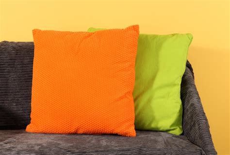 Premium Photo | Colorful pillows on couch on yellow background