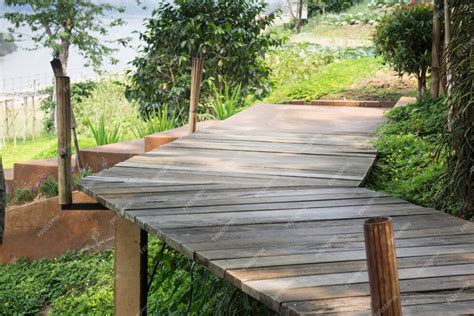 Premium Photo | Wooden walkway with tropical garden