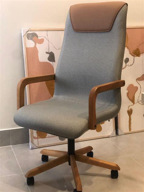 An Office Chair Sitting In Front Of A Painting