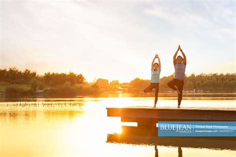 Happy Mature Chinese Couple Doing Yoga In Park High Res Stock Photo For