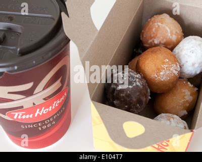 A Tim Hortons coffee cup and Timbits (doughnut holes, donut holes Stock ...