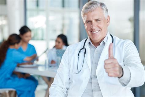 His Patients Really Adore Him A Mature Male Doctor During A Meeting Giving The Thumbs Up Stock