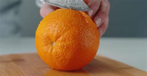 Holding Orange Steady While Knife Slices It In Half Food Stock Footage