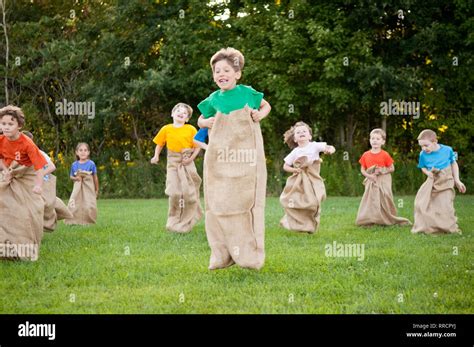 Happy Kids Having Potato Sack Race Outside Stock Photo - Alamy