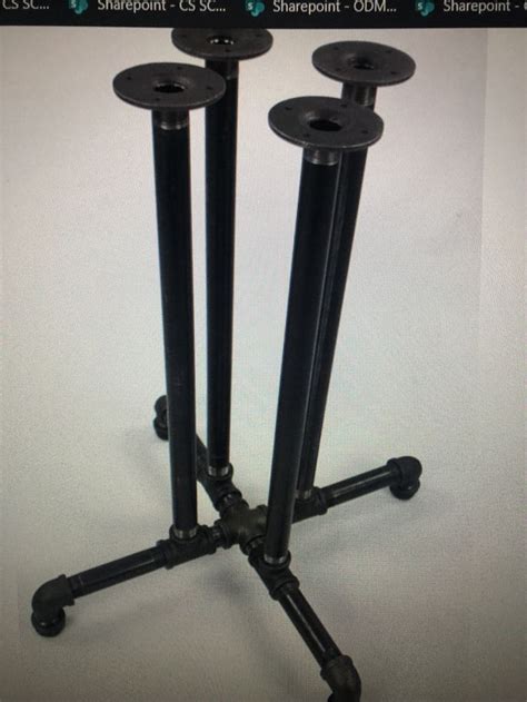 There Are Three Black Metal Poles On This Tripod Stand And One Is