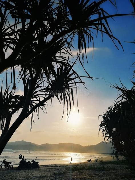 Sunset in the Pulau Merah Beach Stock Photo - Image of people, pulau ...