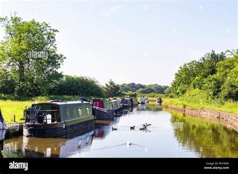 Moored Narrow Boats On The Trent And Mersey Canal In Cheshire England