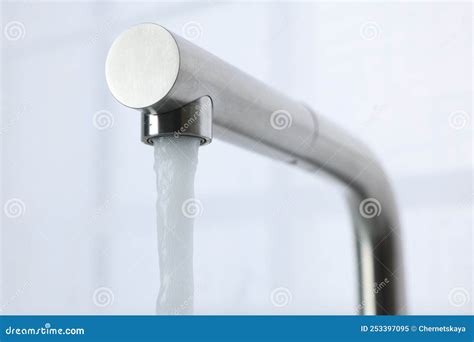 Stream Of Water Flowing From Tap On White Background Closeup Stock