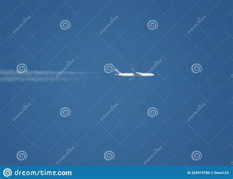 Telephote Side View Of Passenger Jet Flying At High Altitude In A Deep