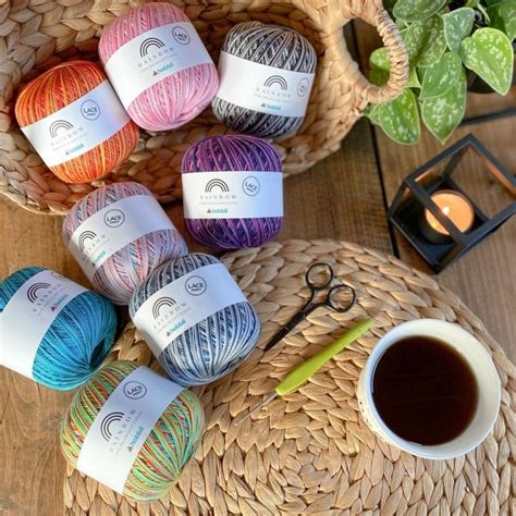 Several Balls Of Yarn Sitting Next To A Cup Of Coffee