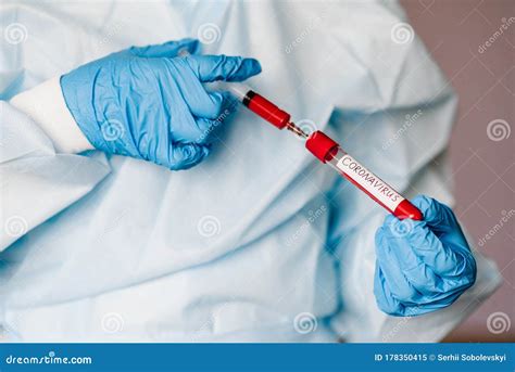 Microbiologist Testing A Tube With Biological Sample Syringe With