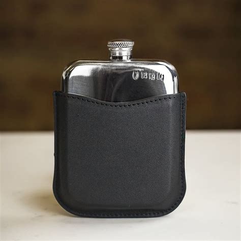 A Black Leather Flask With A Silver Top