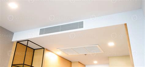 Ceiling Mounted Cassette Type Air Conditioner And Modern Lamp Light On White Ceiling Duct Air