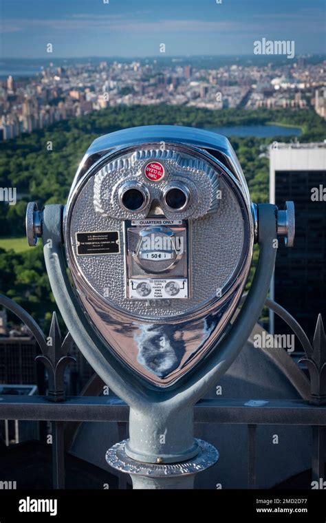 Iconic coin-operated telescope at Top of the Rock observation deck looking over Central Park ...