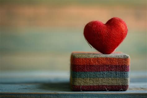 Premium Photo A Red Heart Sitting On Top Of A Box In The Style Of Realism