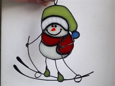 A Stained Glass Ornament Depicting A Snowman