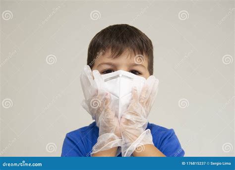 Caucasian Boy Wearing Surgical Mask And Gloves With Her Hands On His