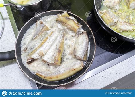 Fish Is Cooked In Two Pans On An Electric Stove Stock Image Image Of