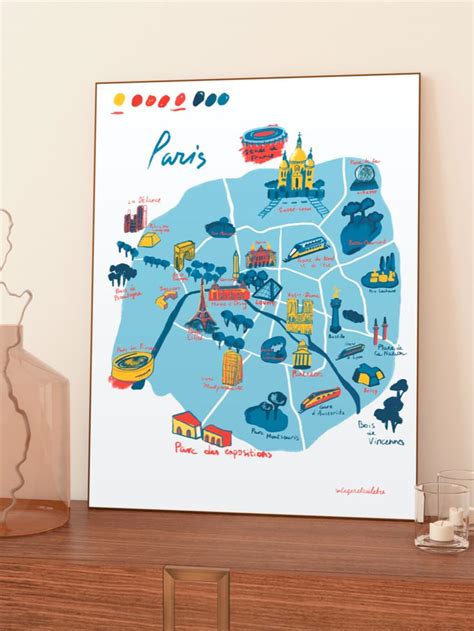 A Framed Map Of Paris Is Shown In Front Of A Cup Of Orange Juice On A Table