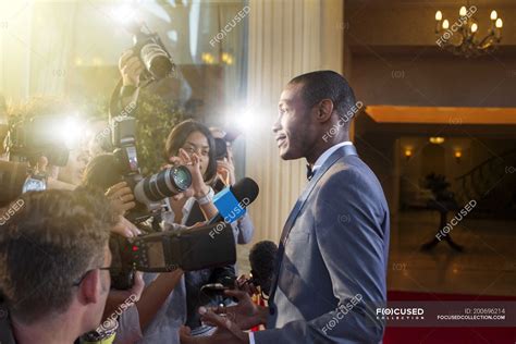 Celebrity Being Interviewed And Photographed By Paparazzi At Red Carpet