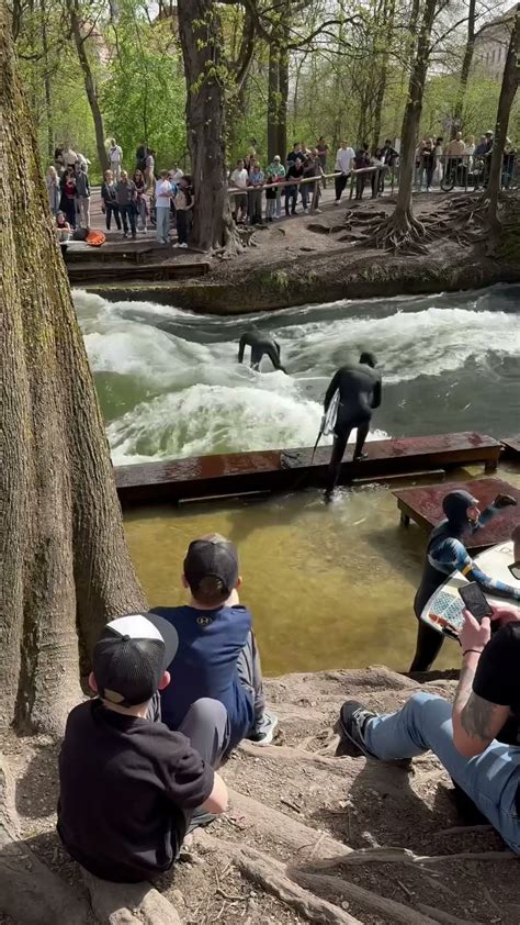 The Eisbach Surfers In Munich Englishgarden Munich River