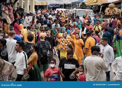 Hindu Devotees Walking Through The Crowd At The Thaipusam Festival In