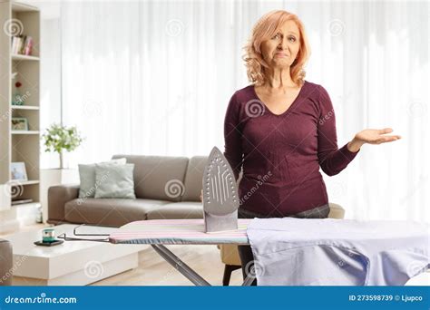 Bored Mature Woman Holding An Iron In A Living Room Stock Image Image Of Lifestyle Housewife