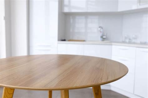 Premium Photo | Solid wood table in a white kitchen round table