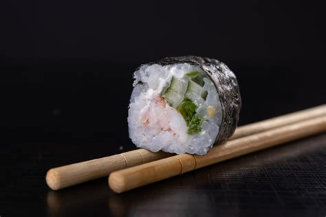 Sushi maki roll with black background | Pictures of food • Foodiesfeed ...