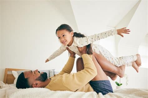 Avion Familial Et Père Avec Une Fille Sur Un Lit Pour Jouer Au Lien Et