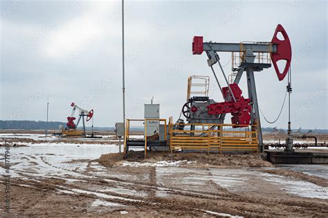 Crude Oil Pump Jack At Oilfield On Sunset Backround Fossil Crude