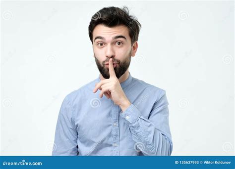 Hispanic Man Placing Finger On Lips As If To Say Shhhhh Be Quiet